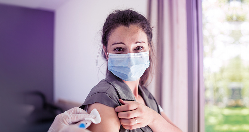 Junge Frau erhält eine jährliche Grippeschutzimpfung als Vorsorge gegen eine Influenza.
